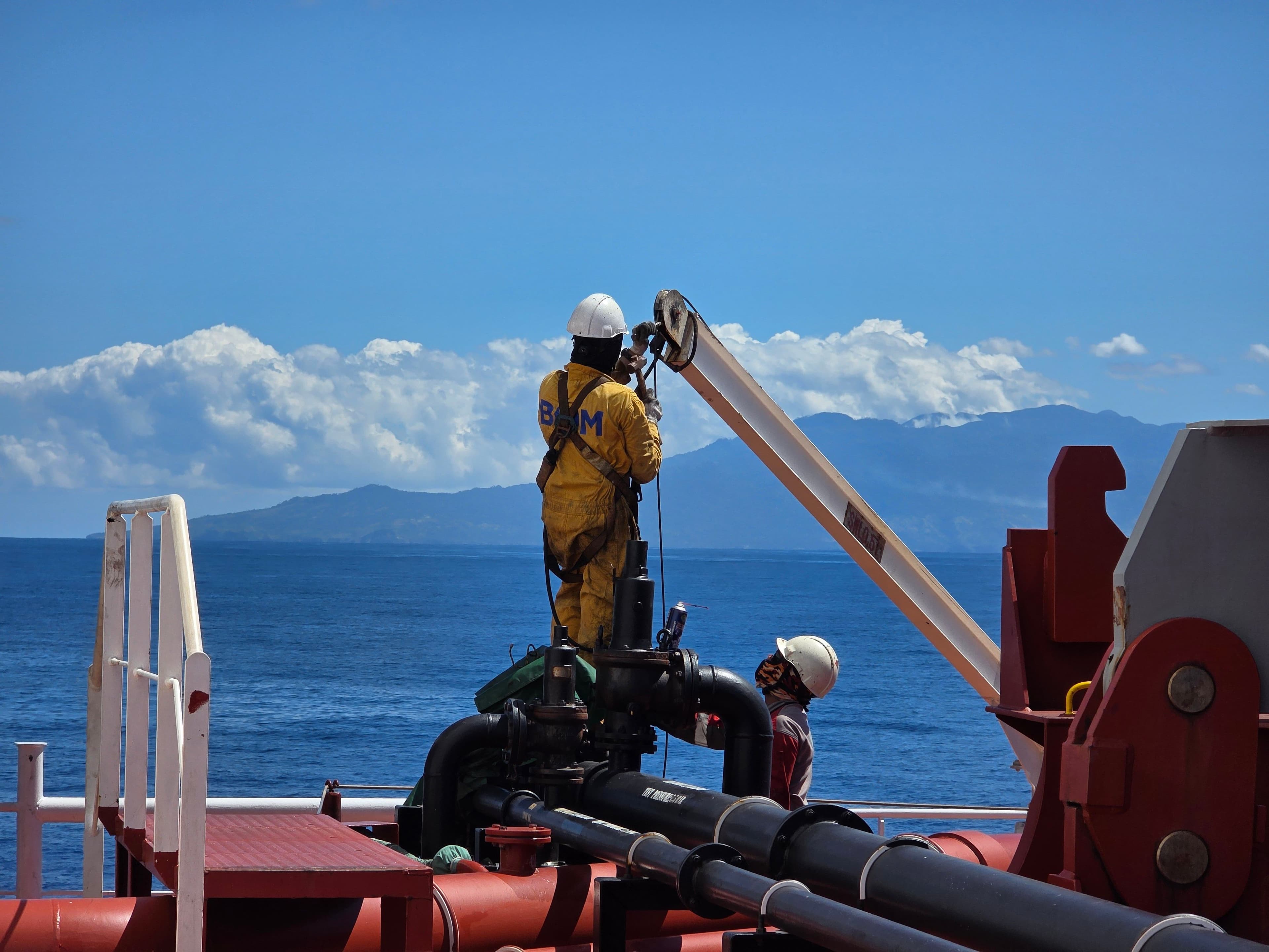 Survey attendance on a vessel deck with marine equipment and open sea