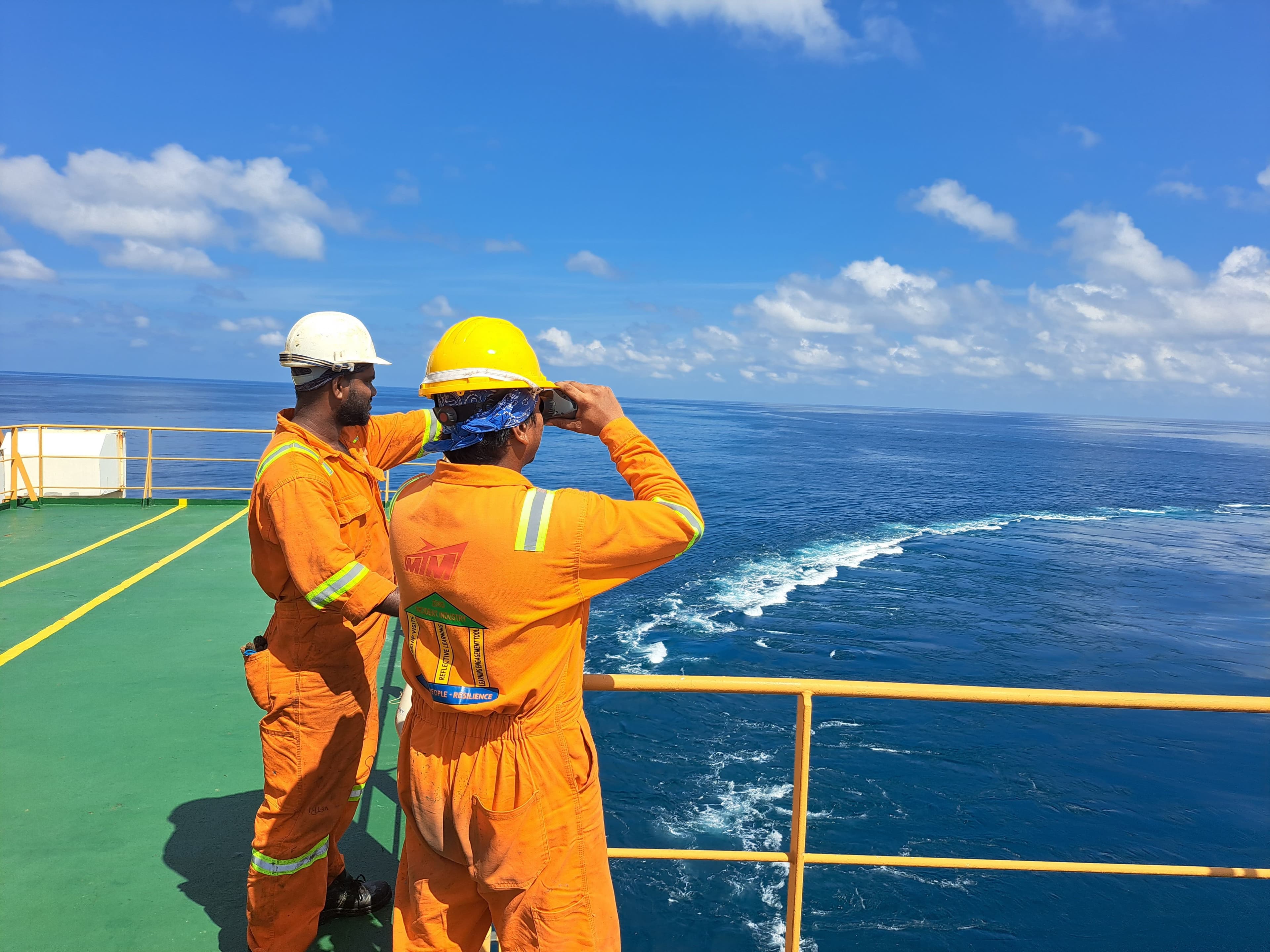 Operational personnel observing conditions from a vessel deck